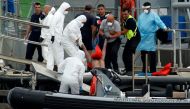 Soldiers carry out the body of a migrant from RHIB, who was found some 68 miles south of Malta by the Armed Forces of Malta maritime squadron and brought on a patrol boat to Marsamxett Harbour, Valletta, Malta August 22, 2018. Reuters/Darrin Zammit Lupi