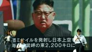 In this file photo taken on September 15, 2017, pedestrians walk in front of a large video screen in Tokyo broadcasting a news report showing North Korean leader Kim Jong-Un, following a North Korean missile test that passed over Japan. / AFP / Toru YAMAN