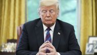 US President Donald Trump listens during a phone conversation with Mexico's President Enrique Pena Nieto on trade in the Oval Office of the White House in Washington on August 27, 2018.