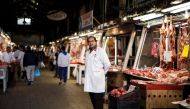 A butcher waits for clients inside the main meat market of Athens, Greece, February 17, 2017. (Reuters/Alkis Konstantinidis) 