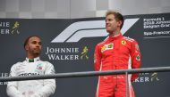 Winner Ferrari's German driver Sebastian Vettel (R) celebrates on the podium next to second placed Mercedes' British driver Lewis Hamilton after the Belgian Formula One Grand Prix at the Spa-Francorchamps circuit in Spa on August 26, 2018. / AFP / EMMANUE