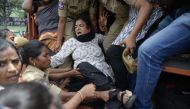Police detains Progressive Organisation for Women (POW) leader Sandhya (C) during a protest against the arrest of poet and activist Varavara Rao in Hyderabad, on August 29, 2018.  AFP / Noah Seelam 