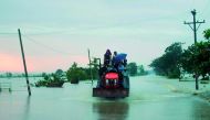 Flood victims ride a farm vehicle in Yedashe township, Bago region after rampaging flood waters from Swar Chaung dam submerged large areas in central Myanmar on August 29, 2018.  AFP / Ye Aung Thu
 