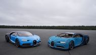 The real Bugatti Chiron on the left with the Lego model.