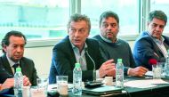Argentine President Mauricio Macri (2nd L) during a meeting with representatives of business chambers and unions to discuss an improvement in the conditions of their groups through greater financial inclusion, in Buenos Aires on August 29, 2018.  AFP / Ar