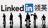 Small toy figures are seen in the backdrop of Linkedin logo in this illustration picture, August 30, 2018. Reuters/Dado Ruvic