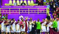 Qatari handball team members and officials celebrate on the podium after winning the gold medal, defeating Bahrain 32-27 in the final during the 2018 Asian Games in Jakarta yesterday.  