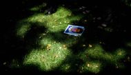 A photo of Barbara Blaine, a sexual abuse victim, is seen on the ground as activists hold a press conference outside the Vatican's US embassy about sexual abuse in the Catholic Church on August 30, 2018 in Washington, DC.  AFP / Brendan Smialowski 
