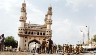 (FILES) In this file photo taken on May 18, 2007 police and members of the media walk around the Char Minar gate in Hyderabad, following a deadly blast at the nearby Macca Masjid mosque. AFP / Noah Seelam 