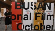 A woman walks past signboards of the Busan International Film Festival (BIFF) after a press conference on the festival overview in Seoul on September 4, 2018. AFP / Jung Yeon-je