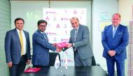 TMQ and QAC officials exchanging documents during the renewal of the supply agreement ceremony.