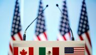 FILE PHOTO: The flags of Canada, Mexico and the U.S. are seen on a lectern before a joint news conference on the closing of the seventh round of NAFTA talks in Mexico City, Mexico, March 5, 2018. REUTERS/Edgard Garrido/File Photo