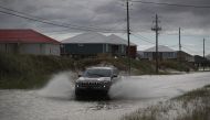 A vehicle drives along a flooded street caused by the approaching Tropical Storm Gordon on September 4, 2018 in Dauphin Island, Alabama. Joe Raedle/Getty Images/AFP