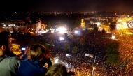 People watch an open-air 
