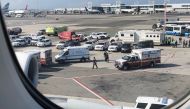 The emergency services are seen, after the passengers were taken ill on a flight from New York to Dubai, on JFK Airport, New York, U.S., September 05, 2018. Larry Coben/ REUTERS 

