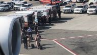 Air cabin crew members and the emergency services are seen leaving the plane, after the passengers were taken ill on a flight from New York to Dubai, on JFK Airport, New York, U.S., September 05, 2018 in this still image obtained from social media. Larry 