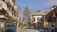 This picture taken in Kafr Ain on September 7, 2018, shows smoke rising as government forces target the city of Khan Shaykhun in the southern countryside of Idlib province. / AFP / Anas AL-DYAB