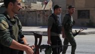 Members of the Asayish, Kurdish internal security police forces, arrive at the site of clashes with regime forces in Qamishly, northeastern Syria, on September 8, 2018.  AFP / Delil SOULEIMAN