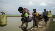 FILE PHOTO: Displaced Rohingya refugees from Rakhine state in Myanmar walk near Ukhia, at the border between Bangladesh and Myanmar, as they flee violence.  AFP / K.M. ASAD
