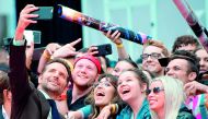 Bradley Cooper takes selfies with fans at the premiere of A Star Is Born during the Toronto International Film Festival, on September 9, 2018, in Toronto, Ontario, Canada. AFP / Valerie Macon
