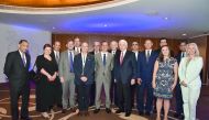 The visiting delegation and some of the attendees pose for a picture.