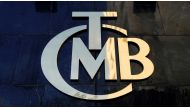 FILE PHOTO: A logo of Turkey's Central Bank (TCMB) is pictured at the entrance of the bank's headquarters in Ankara, Turkey April 19, 2015. REUTERS/Umit Bektas