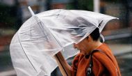 A passerby, using an umbrella, struggles against a heavy rain and wind as Typhoon Jongdari approaches mainland in Tokyo, July 28, 2018. (Reuters / Issei Kato) 