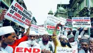 Protestors hold placards as they shout slogans during a protest against what they say is the Chinese government for detaining thousands of Uighur minority Muslims, at a street in Mumbai, India, September 14, 2018. Reuters/Francis Mascarenhas
