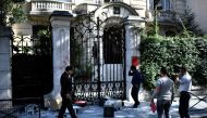 Computers litter the pavement outside the Iranian Embassy in the French capital Paris on September 14, 2018, after people taking part in a demonstration in a near by street split off and walked to the Iranian embassy where they sprayed red paint on the Em