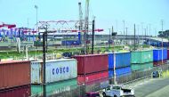 In this file photo taken on July 12, 2018 shipping containers, including those from COSCO, a Chinese state-owned shipping and logistics company await transportation on a rail line at the Port of Long Beach in Long Beach, California.  AFP / Frederic J BROW