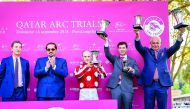 The winning horse in the Qatar Cup – Prix Dragon (Gr1/PA), Yaseed’s jockey Olivier Peslier (centre), trainer Alban de Mieulle, (right) and a team representative celebrate during the presentation ceremony with Qatar Racing and Equestrian Club (QREC) Genera