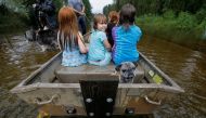 Iva Williamson, 4, peers behind her as she joins neighbors and pets in fleeing rising flood waters in the aftermath of Hurricane Florence in Leland, North Carolina, U.S., September 16, 2018. REUTERS/Jonathan Drake 