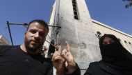 A man and a woman show their ink-stained index fingers after voting for Syria's first local elections since 2011, on September 16, 2018 in the southern Eastern Ghouta, on the eastern outskirts of the capital Damascus. AFP / LOUAI BESHARA