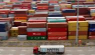 FILE PHOTO: A container truck moves past containers at the Yangshan Deep Water Port in Shanghai, China April 24, 2018. REUTERS/Aly Song/File Photo