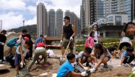 Volunteers clear a damaged path after Super Typhoon Mangkhut hit Hong Kong, China September 18, 2018. REUTERS/Tyrone Siu	
