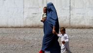 FILE PHOTO: An Afghan refugee woman arrives with her children to be repatriated to Afghanistan, at the United Nations High Commissioner for Refugees (UNHCR) office on the outskirts of Peshawar, Pakistan April 3, 2017. REUTERS/Fayaz Aziz