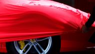 FILE PHOTO: A partially covered Ferrari car is pictured before the opening of the Frankfurt Motor Show (IAA) in Frankfurt, Germany, September 11, 2017. REUTERS/Kai Pfaffenbach