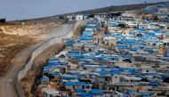 FILE PHOTO: A wall along the border between Turkey and Syria is pictured at the Syrian town of Atimah, Idlib province, in this picture taken from Reyhanli, Hatay province, Turkey October 10, 2017. REUTERS/Osman Orsal