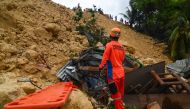 Rescuers search for survivors at a landslide site in Naga City, on the popular tourist island of Cebu on September 20, 2018.  AFP / ALAN TANGCAWAN