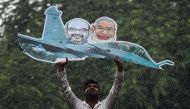 A supporter of the Indian Youth Congress holds a model of a Rafale fighter jet as he gets detained by Indian police during a protest in New Delhi on September 22, 2018. AFP / CHANDAN KHANNA