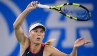 Caroline Wozniacki of Denmark hits a return against Rebecca Peterson of Sweden during their women's singles third round match of the WTA Wuhan Open tennis tournament in Wuhan on September 25, 2018. / AFP / NICOLAS ASFOURI 