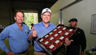 Australian Prime Minister Scott Morrison, flanked by the Liberal Member for Fisher Andrew Wallace, poses with a tray of strawberries during a visit to the Ashbern strawberry farm on the Sunshine Coast, Australia, September 27, 2018. AAP/Dan Peled/via REUT