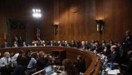 Members of the Senate Judiciary Committee listen as Sen. Jeff Flake (L) (R-AZ) speaks with Sen. Chris Coons (D-DE) after Flake announced he is in favor of additional time in the Kavanaugh investigation September 28, 2018 in Washington, DC. Win McNamee/Get