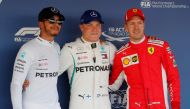 Mercedes' Valtteri Bottas (C) after qualifying in pole position with teammate Lewis Hamilton (L), who qualified second and Ferrari's Sebastian Vettel, who qualified third REUTERS/Maxim Shemetov