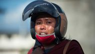 Samidah, a relative of a victim, cries while gathered outside the collapsed Roa Roa hotel in Palu, Indonesia's Central Sulawesi on September 30, 2018, following the September 28 earthquake and tsunami.  AFP / Bay Ismoyo
 