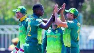 South Africa's Lungi Ngidi (L) celebrates after dismissing Zimbabwe's Kyle Jarvis during the first One Day International cricket match between South Africa and Zimbabwe at the Diamond Oval in Kimberley on September 30, 2018. AFP / Wikus De Wet

