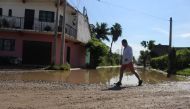 Librado Conseudra Pascacio walks along a rain-flooded street in Jarretaderas, Mexico on September 13, 2018. Thomson Reuters Foundation