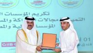 Jamal Abdullah Al Jamal (right), QIIB Deputy CEO, receiving the Banking Excellence for Partnership and Corporate Social Responsibility (CSR) Award, 2018, on behalf of the bank.