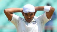 Indian cricketer Prithvi Shaw ties a bandana on his head during the first day of the first Test cricket match between India and West Indies at the Saurashtra Cricket Association stadium in Rajkot on October 4, 2018. GETTYOUT / AFP / INDRANIL MUKHERJEE
