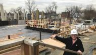 Arlington Presbyterian Church elder Susan Etherton points to the church’s future site as construction proceeds 19 March 2018 on a new affordable housing development in Arlington, Virginia. Handout photo by Susan Etherton